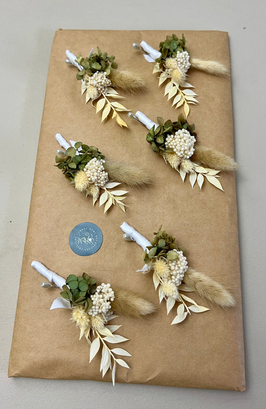 Floral arrangements on a brown paper bag with a blue sticker.
