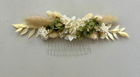 Floral hair comb with dried flowers and leaves on a gray background