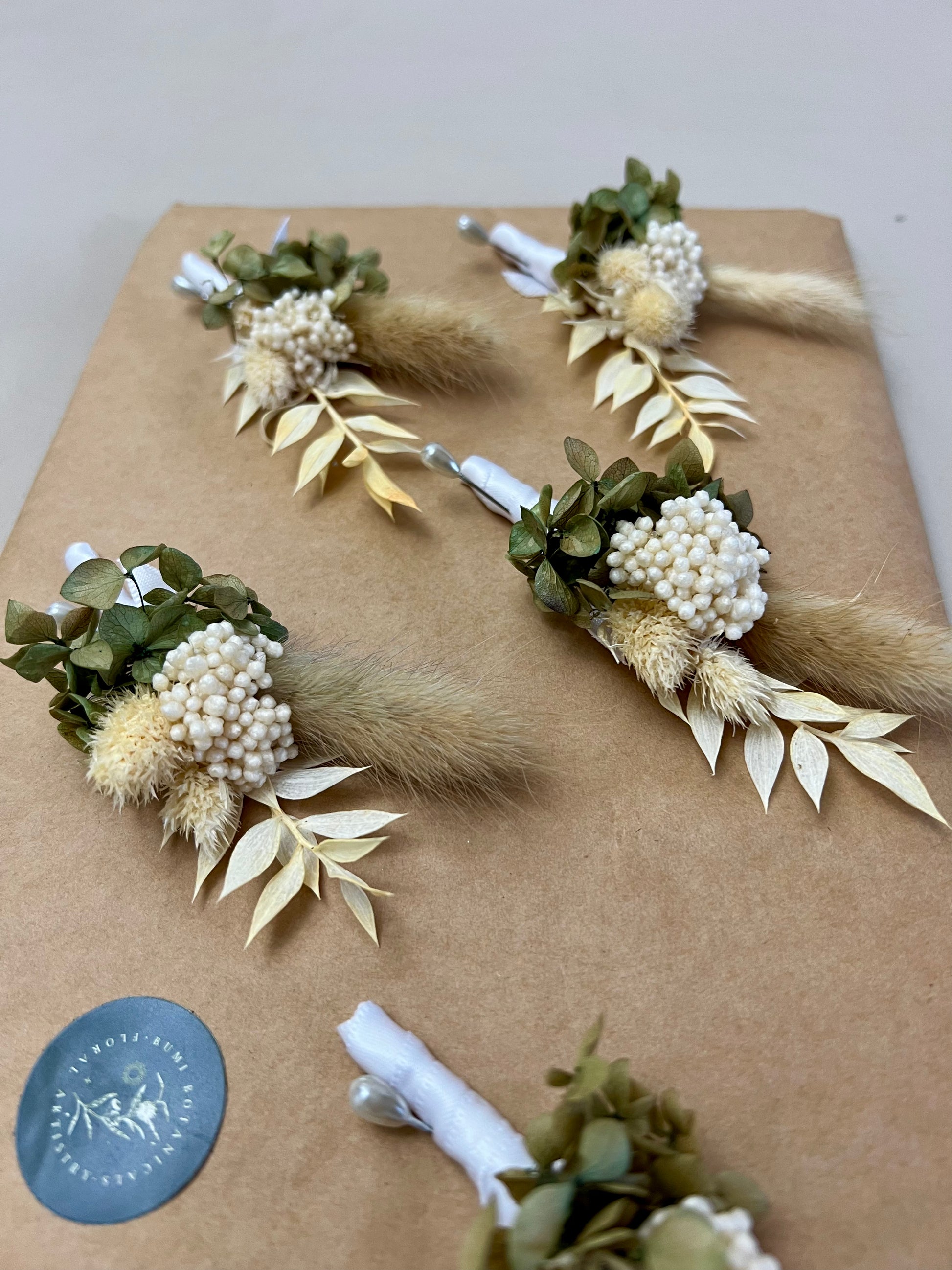 Floral arrangements on brown paper with a visible brand logo.